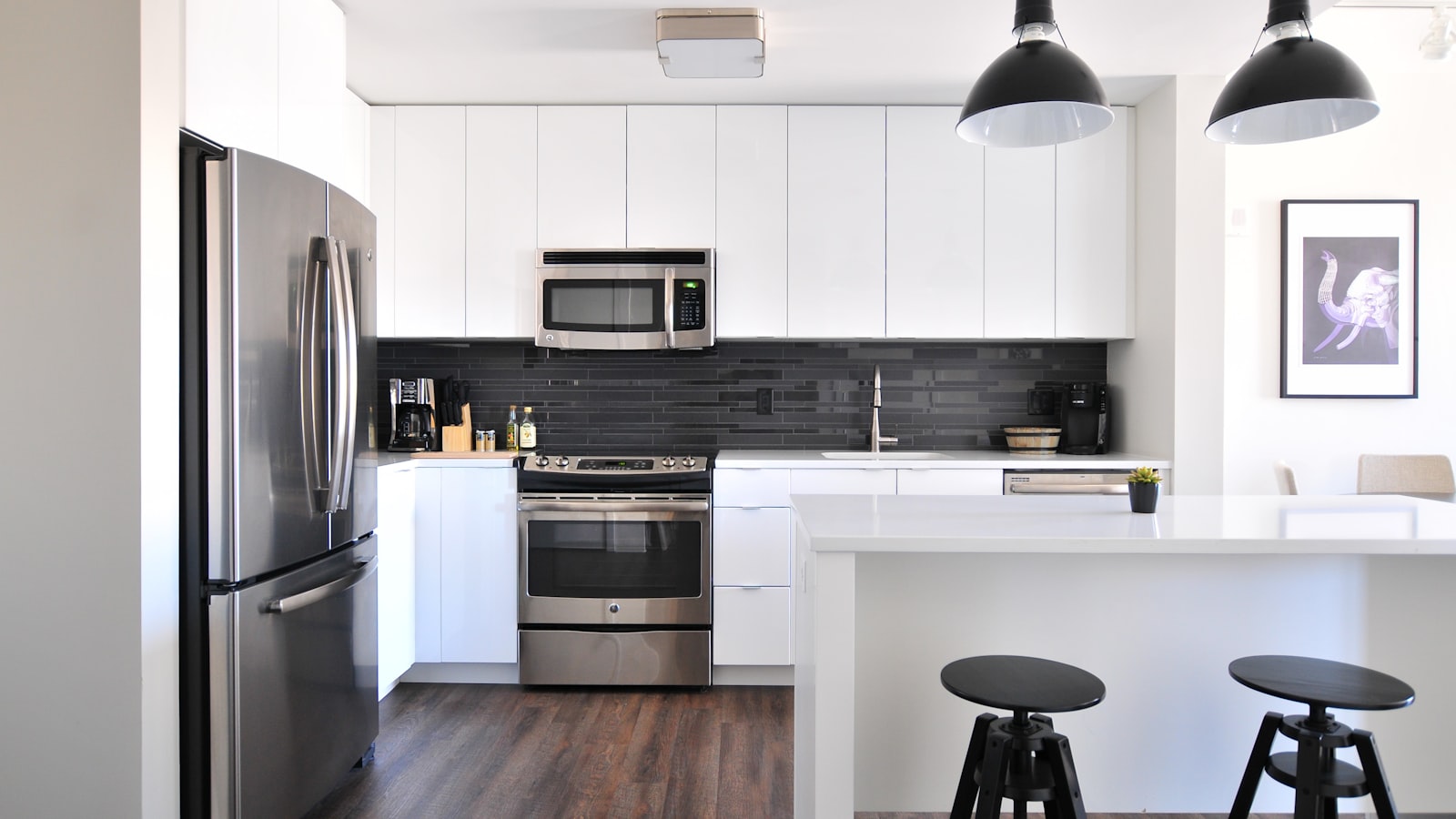 Sunlit open-plan kitchen and living room with a wooden table and household chairs