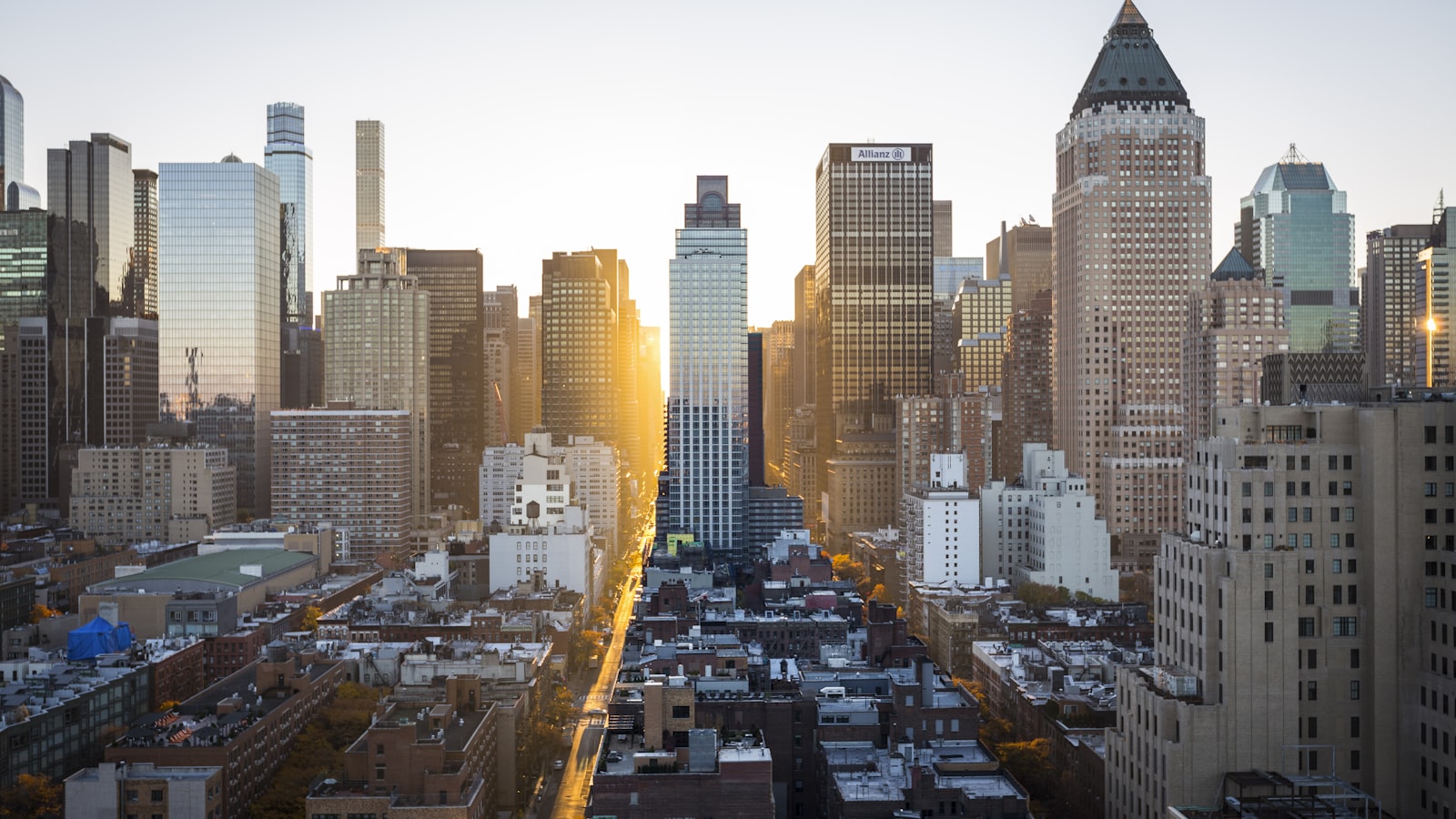 City skyline at dusk with scattered window lights spreading to the horizon