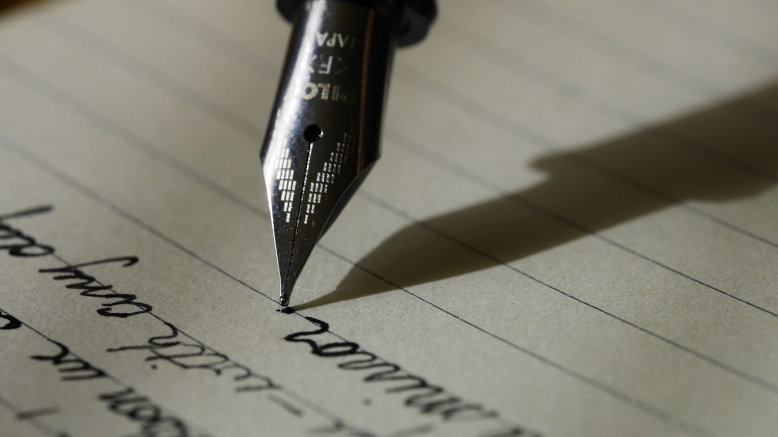 Black manual typewriter with a blank sheet of paper rolled into the platen